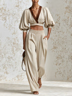 Elegant Beige Two-Piece Trouser Set For Women — V-Neck Puff-Sleeve Cropped Top And High-Waisted Wide-Leg Trousers